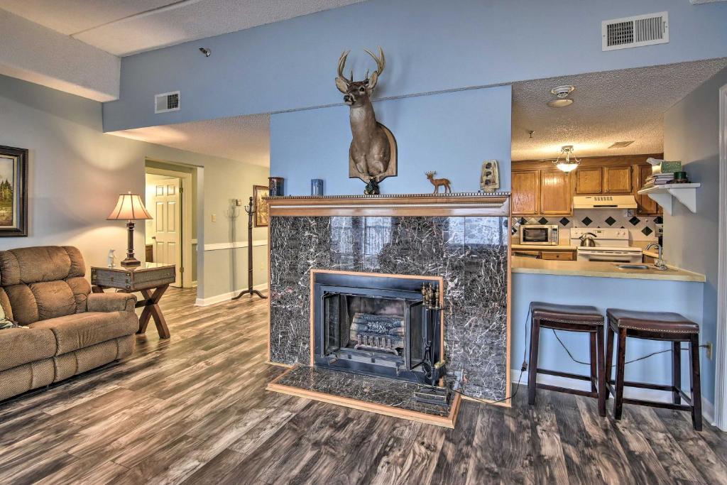 a living room with a fireplace with a deer head above it at Cozy Retreat Less Than 4 Mi to Sugar Mountain Resort! in Sugar Mountain