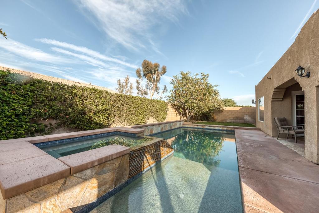 a swimming pool in the backyard of a house at Tranquil Retreat Permit# 50437 in Indio
