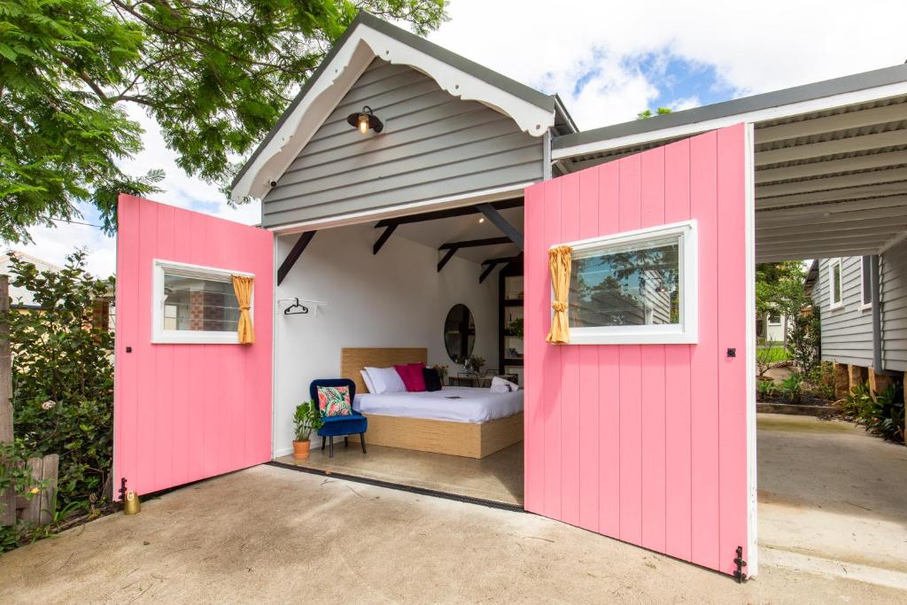 a pink shed with a bed in a bedroom at Nowra Studio Barn in Nowra