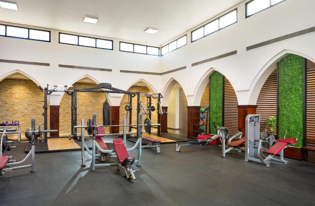a gym with cardio equipment in a building at Metropolitan Al Mafraq Hotel in Abu Dhabi