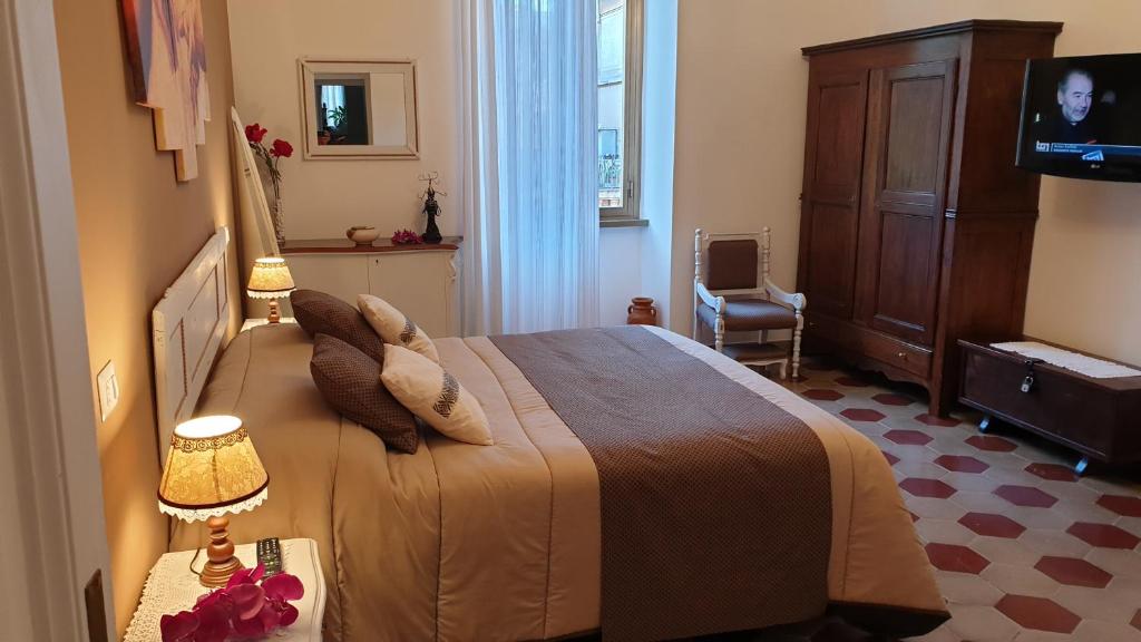 a hotel room with a bed and a tv at Casa Ferrari Testaccio e Trastevere Wi-Fi free in Rome