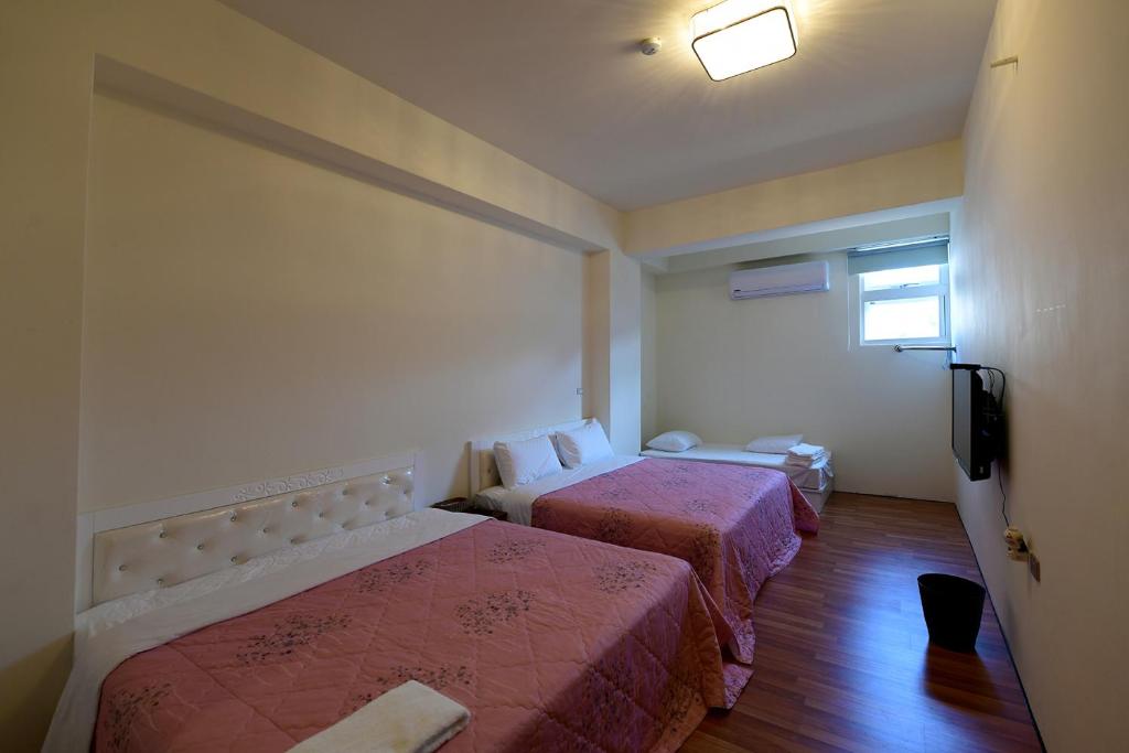 Postel nebo postele na pokoji v ubytování Light Time Homestay