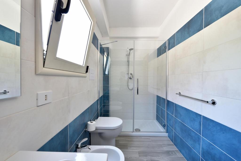 a bathroom with a white toilet and a shower at Casa Cala Sisine in Santa Maria Navarrese