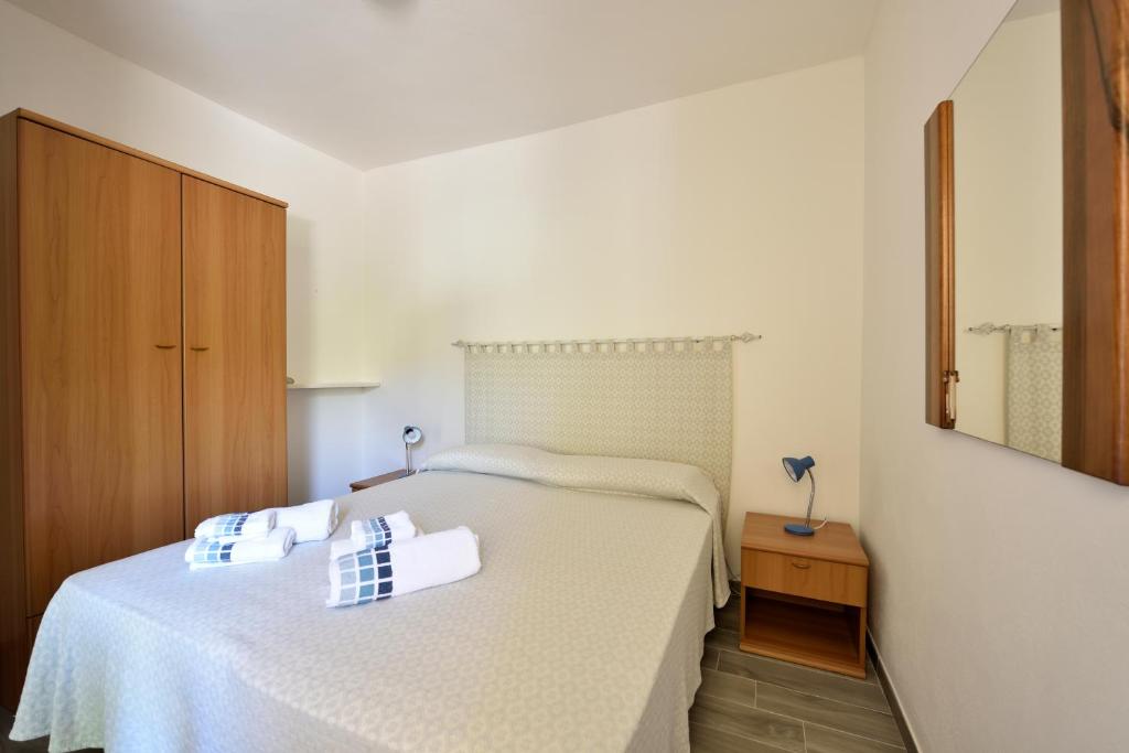 a bedroom with a bed with two towels on it at Casa Cala Sisine in Santa Maria Navarrese