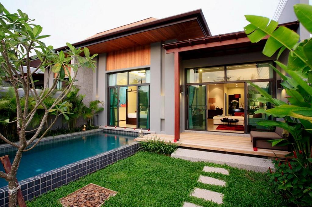 uma villa com uma piscina e uma casa em Two Villas HOLIDAY - Onyx Style Nai Harn Beach, Phuket em Nai Harn Beach