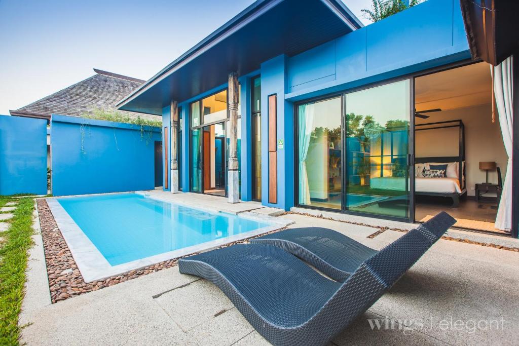 a swimming pool in the backyard of a house at Wings Phuket Villa by Two Villas HOLIDAY in Bang Tao Beach