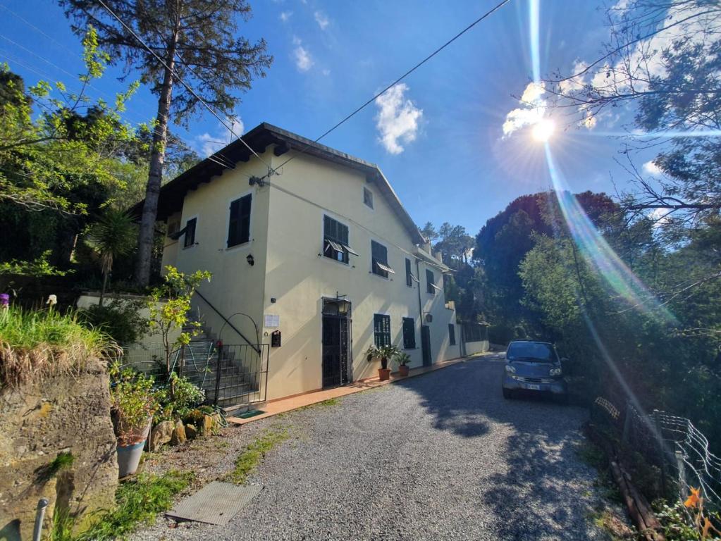 a car parked on a road next to a white house at B&B Casale Coreallo Spotorno in Spotorno