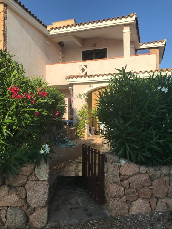 a house with a gate in front of it at Tavolara Paradise Home in Porto San Paolo