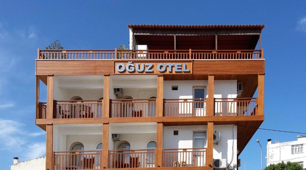 an apartment building with a sign on it at Oğuz Otel Datça in Mugla