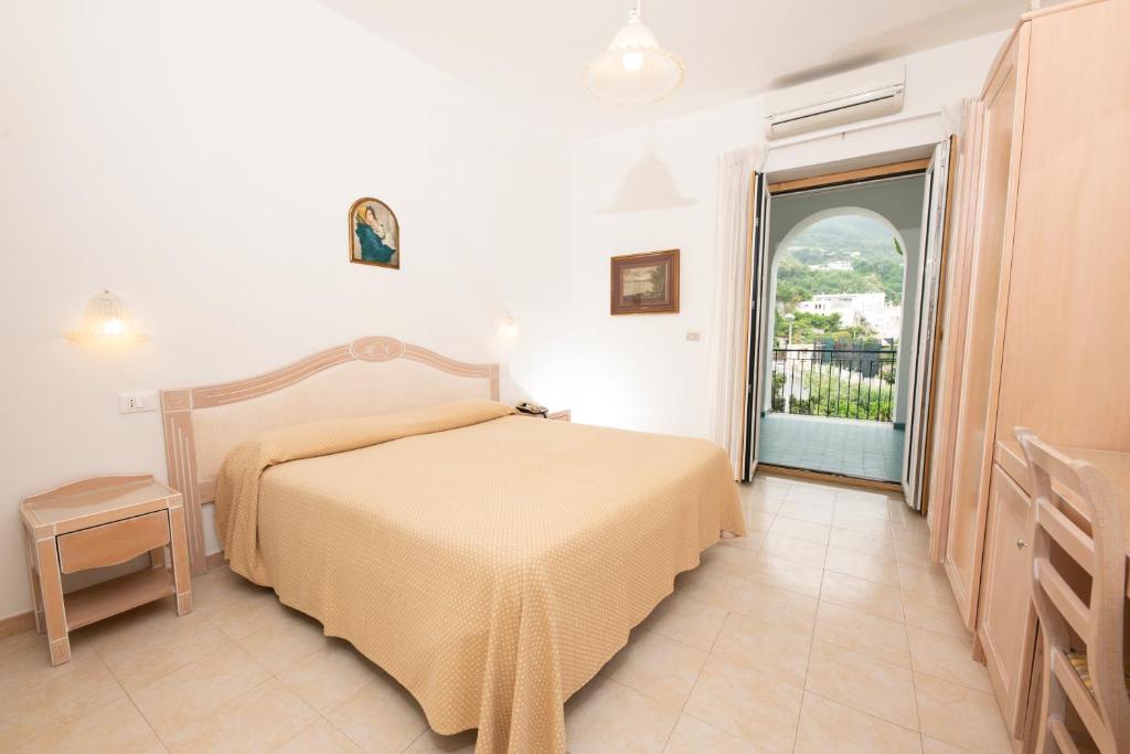 Postel nebo postele na pokoji v ubytování Hotel Candia
