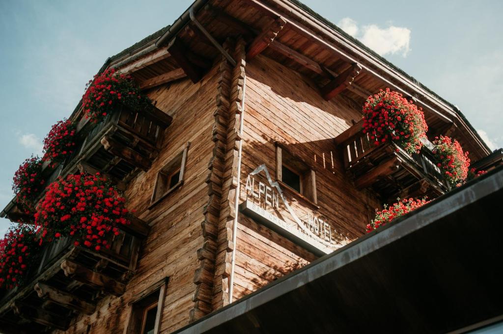 a building with flower boxes on the side of it at Alpen Hotel Chalet in Valdidentro