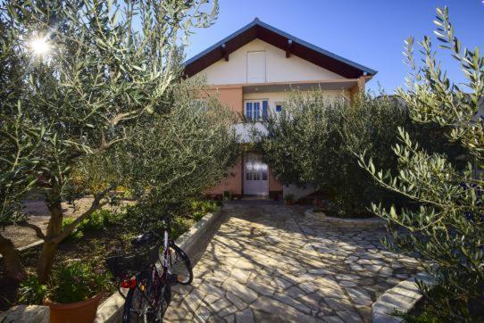 a house with a bike parked in front of it at Apartment Luna in Tisno