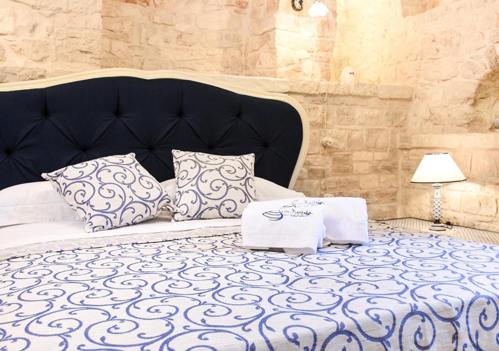 Łóżko lub łóżka w pokoju w obiekcie Trulli e Puglia Luxury Suite