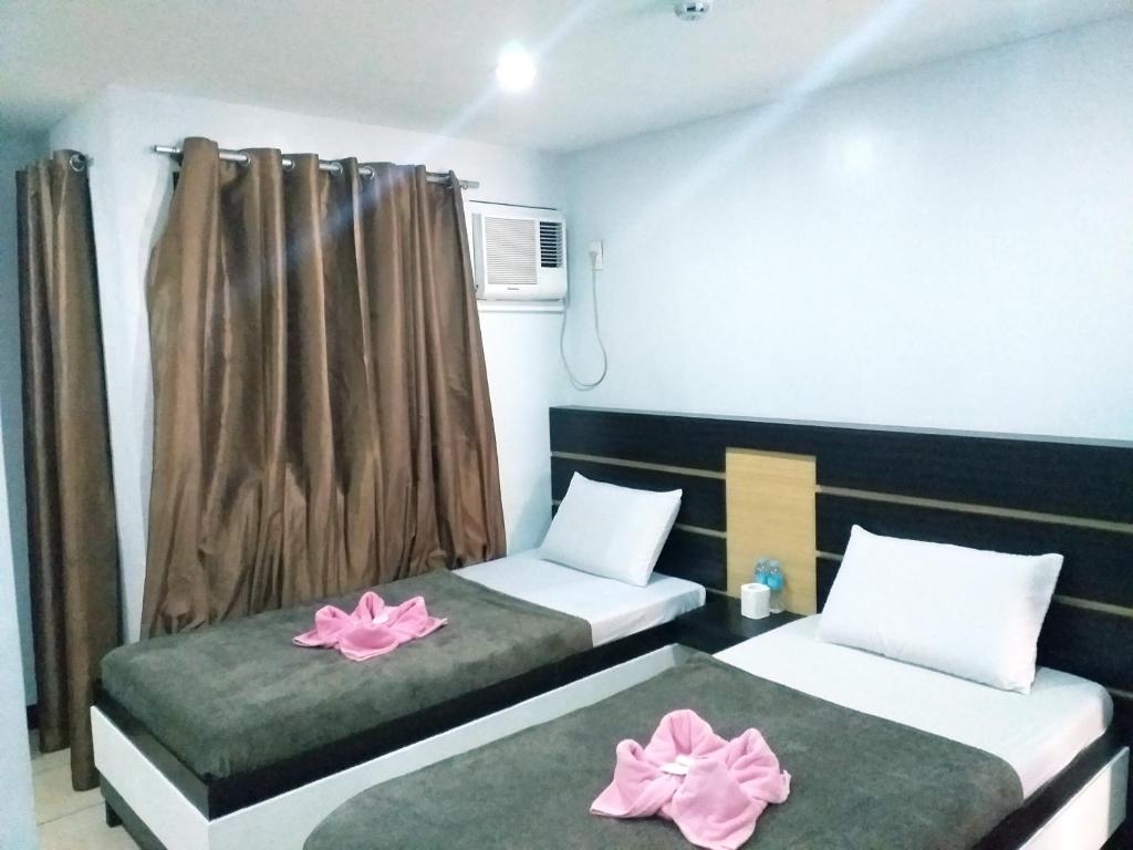 Postel nebo postele na pokoji v ubytování Global 88 Apartelle