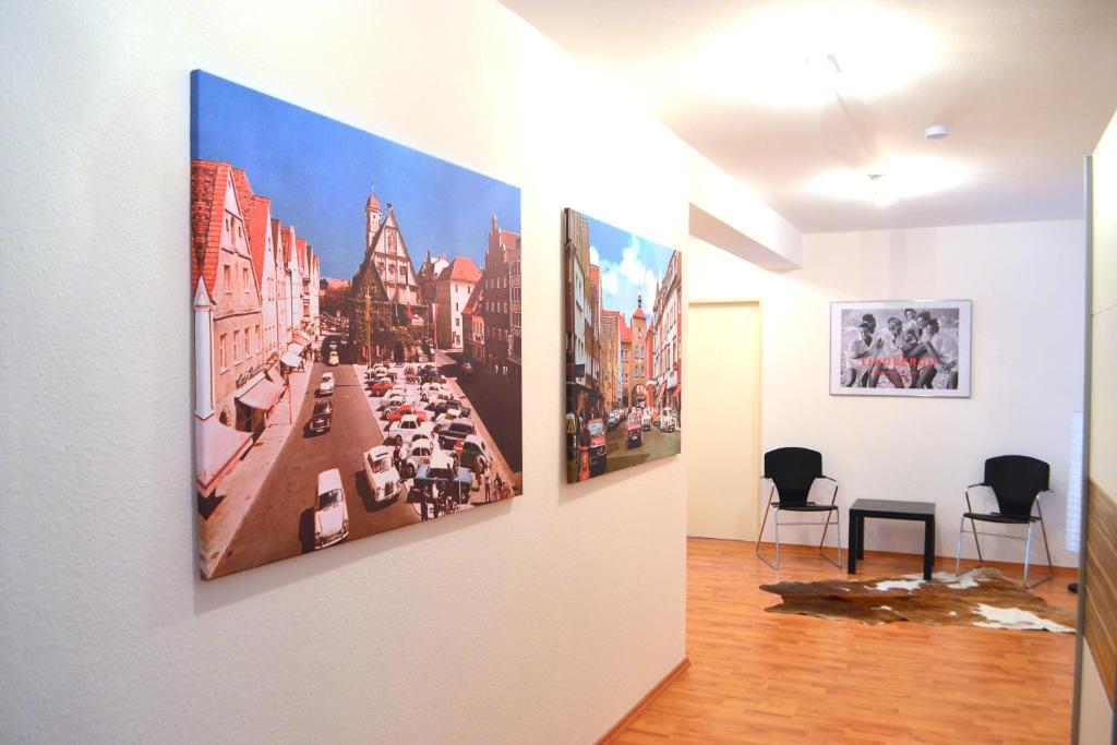a room with three paintings on the wall at Ciao - Wohnen charmant & zentral in Weiden in Weiden