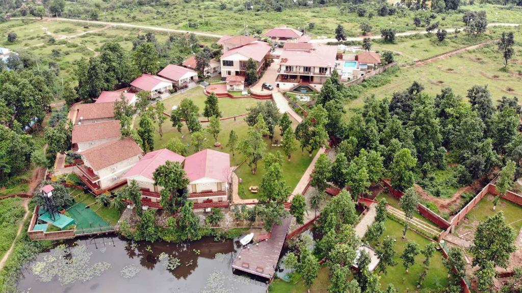 an aerial view of a large house with a lake at Kushal Palli Resorts- A unit of PearlTree Hotels & Resorts in Purulia