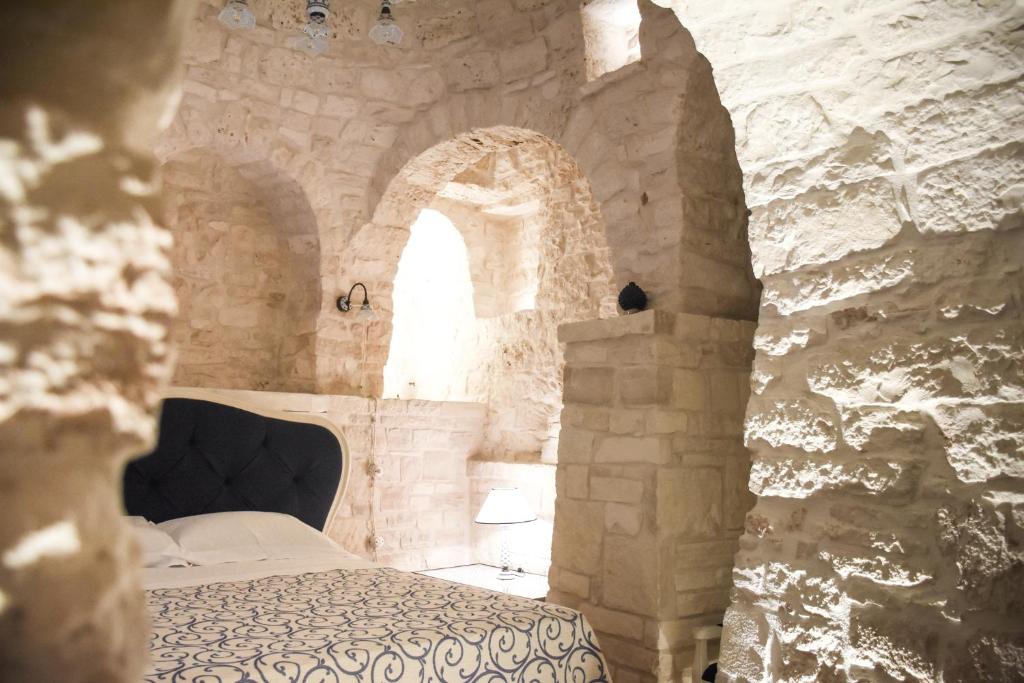Łóżko lub łóżka w pokoju w obiekcie Trulli e Puglia Luxury Suite