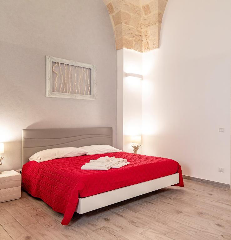 sypialnia z czerwonym łóżkiem i czerwonym kocem w obiekcie B&B Casa di Anita w mieście Arnesano