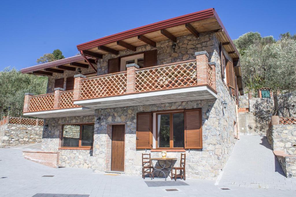 a stone house with a balcony on top of it at Casa Ziretto in Castelmola