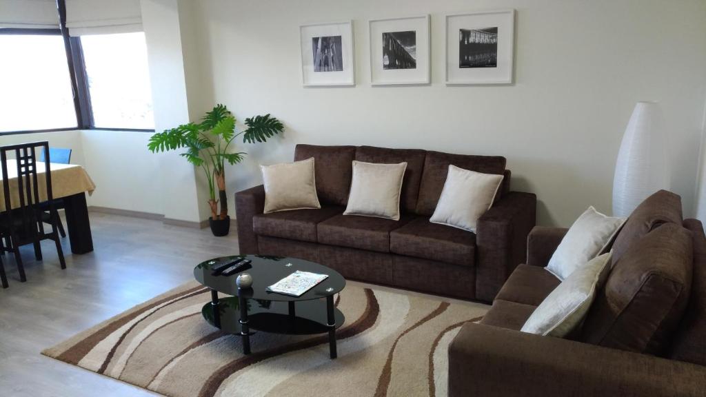 a living room with a couch and a table at StaynFeel 03 in Fátima