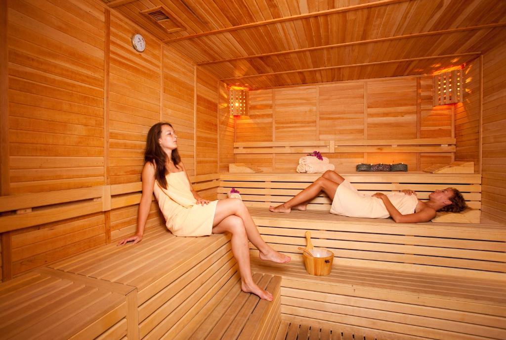 two women are sitting in a sauna at Limak Atlantis Deluxe Hotel Belek in Belek