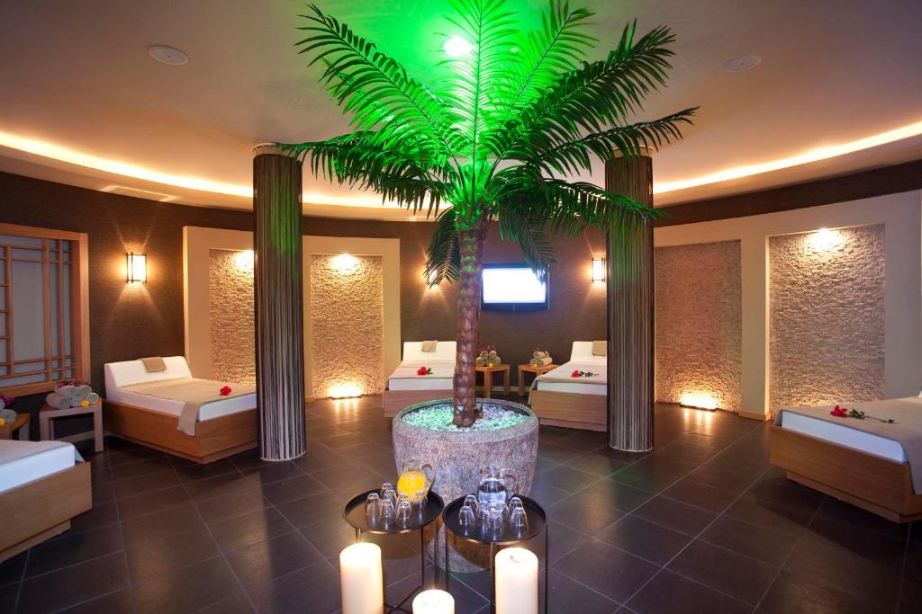 a hotel room with two beds and a palm tree at Limak Atlantis Deluxe Hotel Belek in Belek