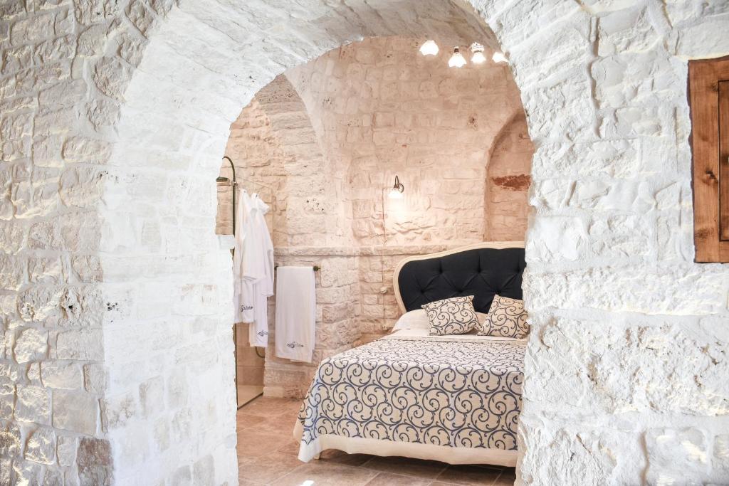 Łóżko lub łóżka w pokoju w obiekcie Trulli e Puglia Luxury Suite
