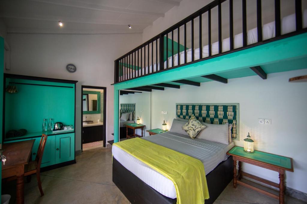 a bedroom with a large bed and a staircase at Parawa House in Galle