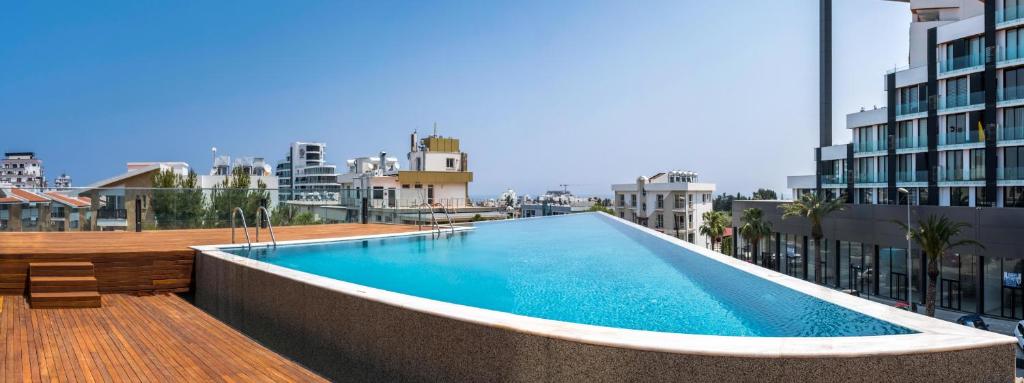 a swimming pool on the roof of a building at Deluxe Apt w/ Rooftop Pool in The Heart of Kyrenia in Kyrenia