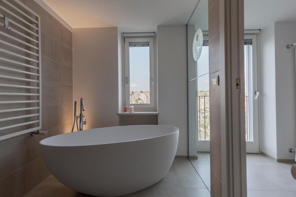 a white bath tub in a bathroom with a window at LAMIA MATERA 11 in Matera