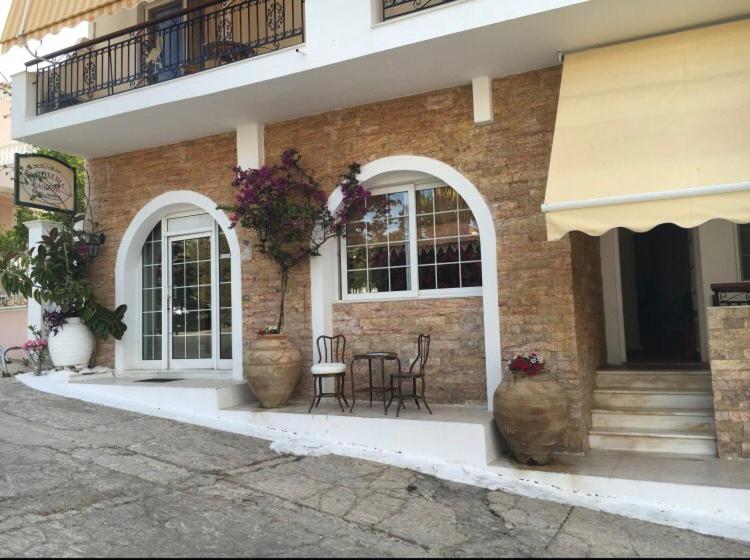 a brick building with a table and chairs in front of it at PHILOXENIA PENSION in Ermioni