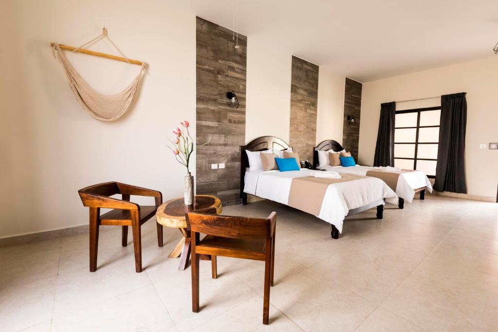 Postel nebo postele na pokoji v ubytování Hotel Los Frailes, Valladolid, Yucatán