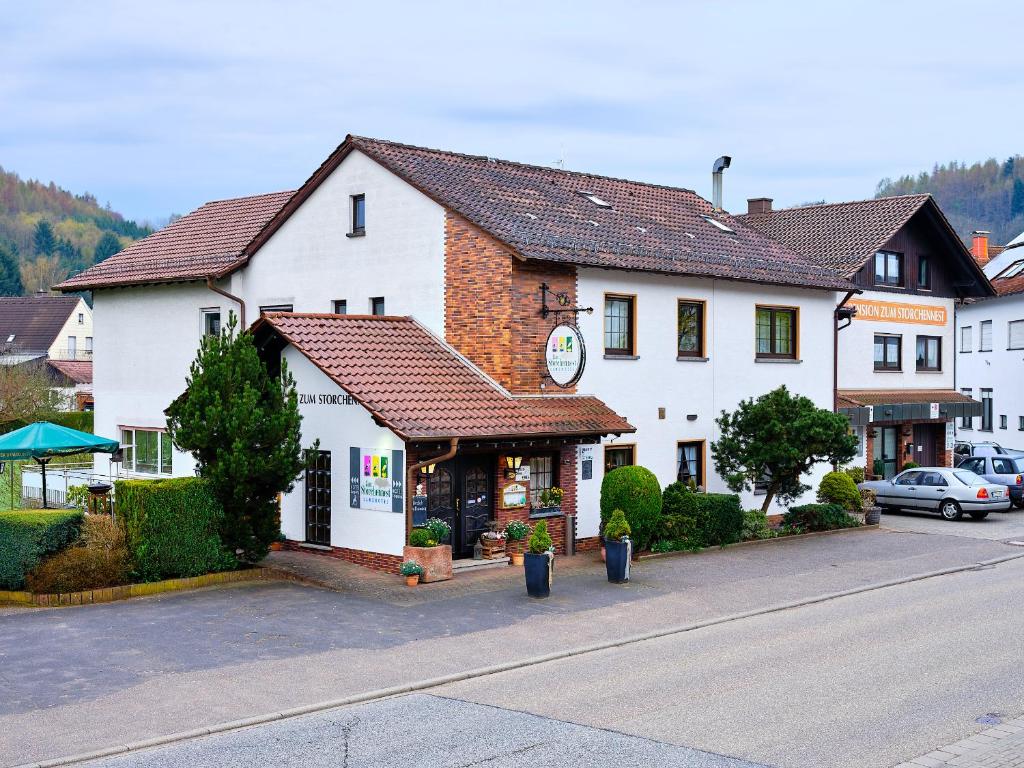 a large white building with a store in a street at Ferienwohnung Borst in Bann