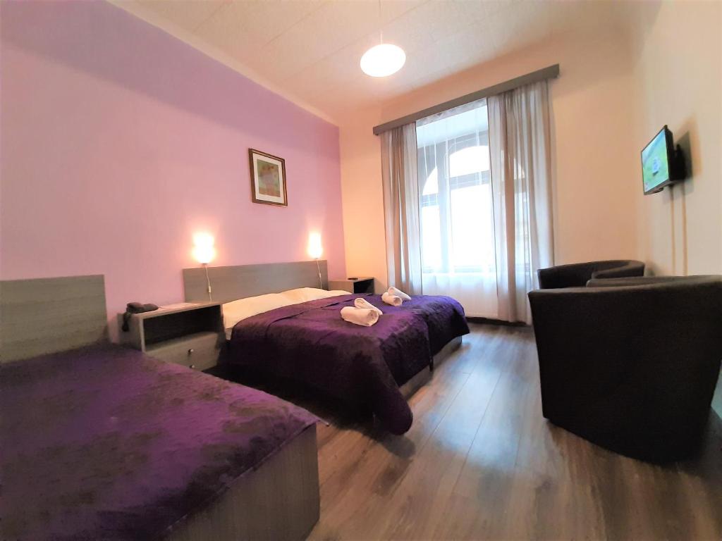 Łóżko lub łóżka w pokoju w obiekcie Hotel Olga