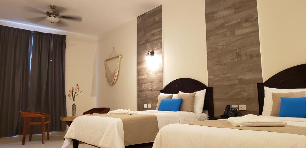 Postel nebo postele na pokoji v ubytování Hotel Los Frailes, Valladolid, Yucatán