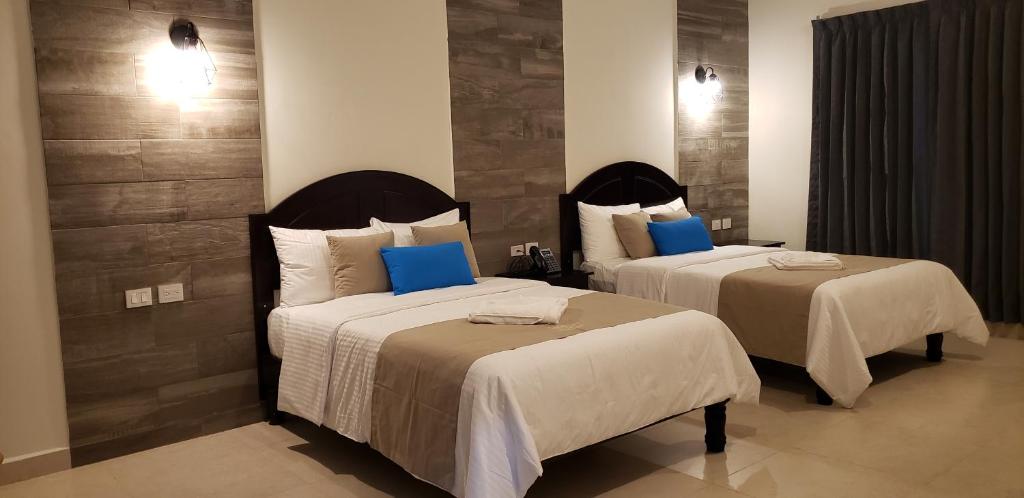 Postel nebo postele na pokoji v ubytování Hotel Los Frailes, Valladolid, Yucatán