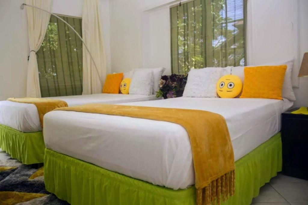 a bedroom with two beds with faces on them at E 20 Mystic Ridge ocho Rios in Ocho Rios