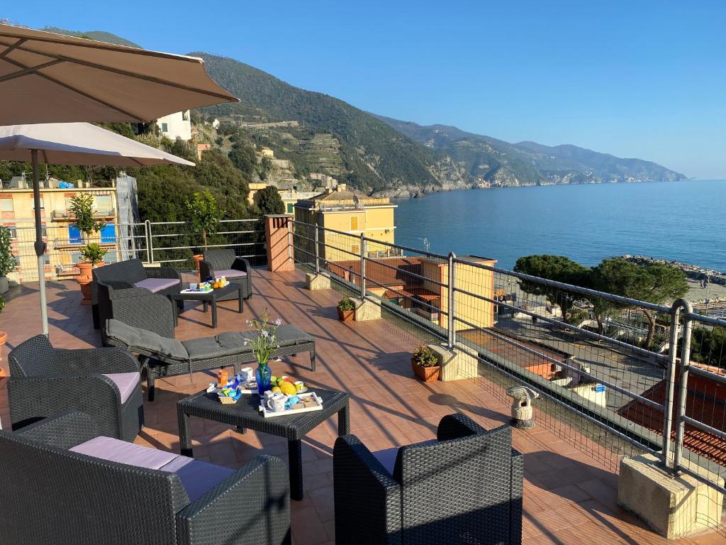 a balcony with tables and chairs and a view of the ocean at La Casa sul Mare - Monterosso - Cinque Terre in Monterosso al Mare