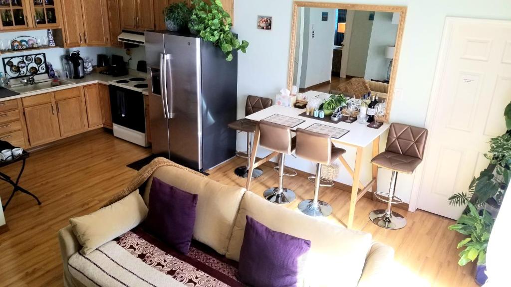 a kitchen with a couch and a table with a refrigerator at LUXURY 2BR/1BA OASIS IN SAN JOSE CA in San Jose