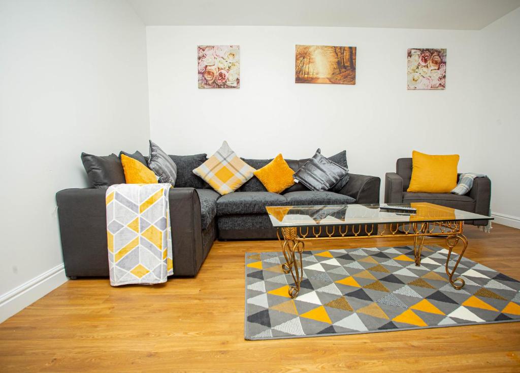 a living room with a couch and a coffee table at Somerset Place in Northampton