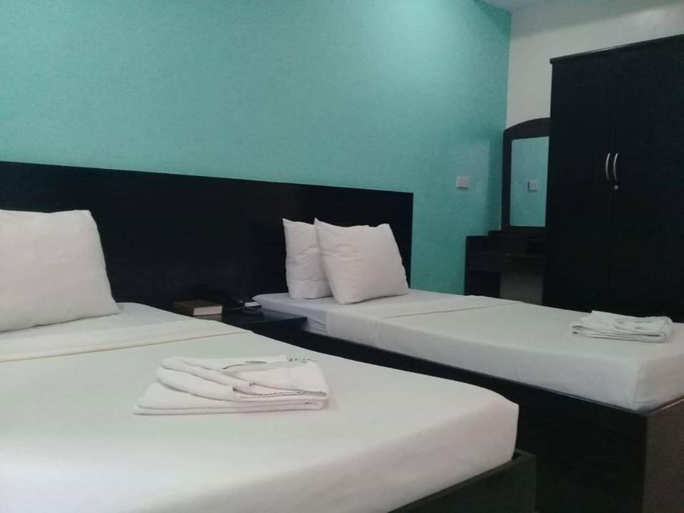 Postel nebo postele na pokoji v ubytování Coron Visitors Hotel