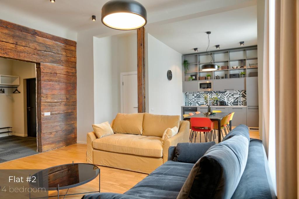 a living room with a couch and a table at Dandelion Apartments Matīsa in Riga