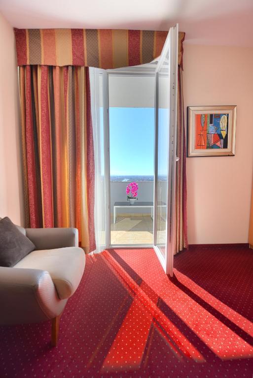 a living room with a door open to a patio at Jolly Hotel in Lezhë
