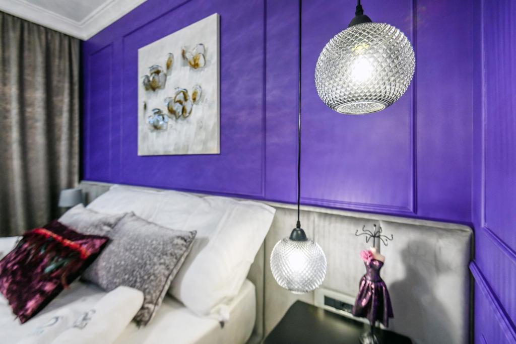 a purple room with a couch and a table at DiVine Luxury Apartment Purple in Zadar