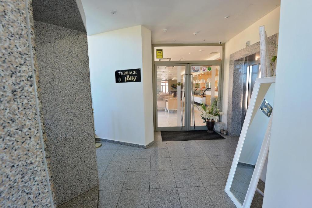 a lobby of a store with a sign on the wall at Jolly Hotel in Lezhë