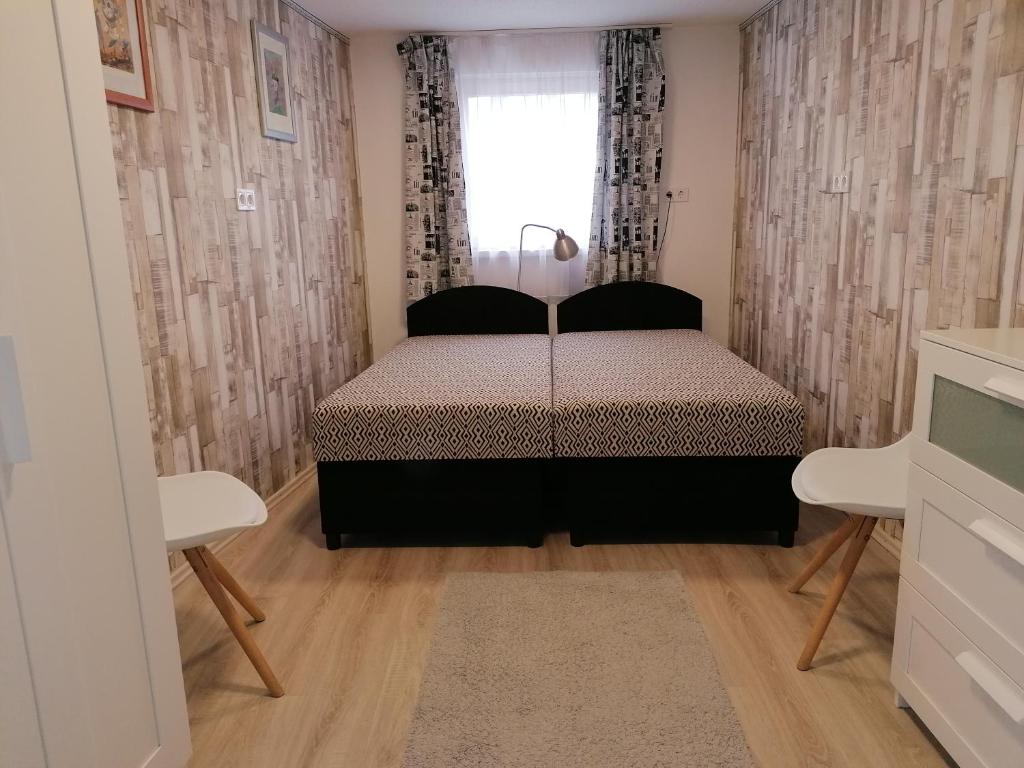 Postel nebo postele na pokoji v ubytování Tabán Apartman