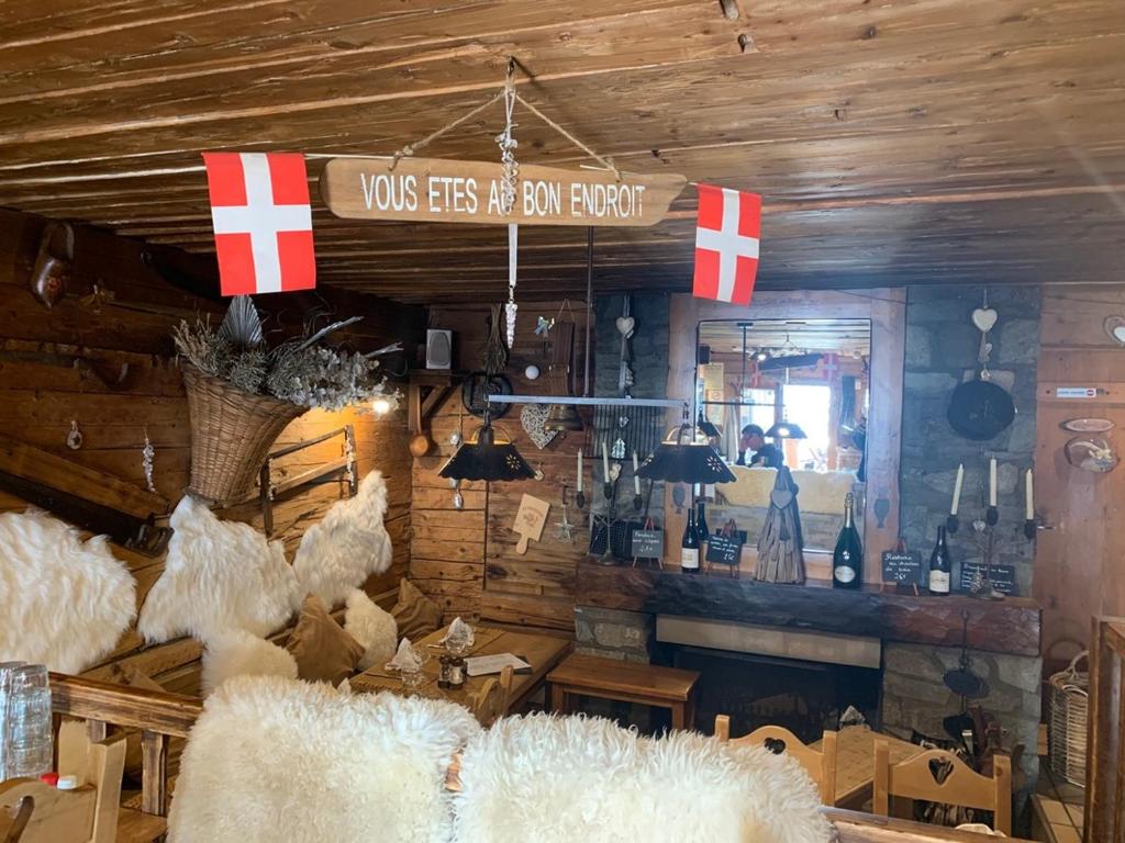 a room with a bar with swiss flags on the wall at La Bournerie in Le Grand-Bornand