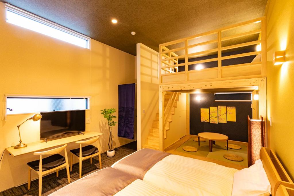 a bedroom with a bed and a desk and a bunk bed at Sakura Stay Keikyukamata in Tokyo