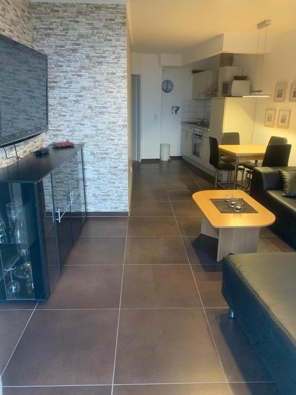 a living room with a couch and a table at Ferienwohnung 210 Vitamar in Schmarren