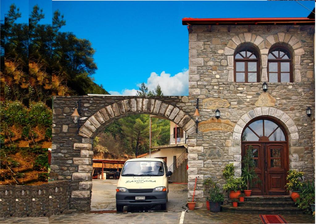 a white van parked in front of a stone building at Konitsa Panorama in Konitsa